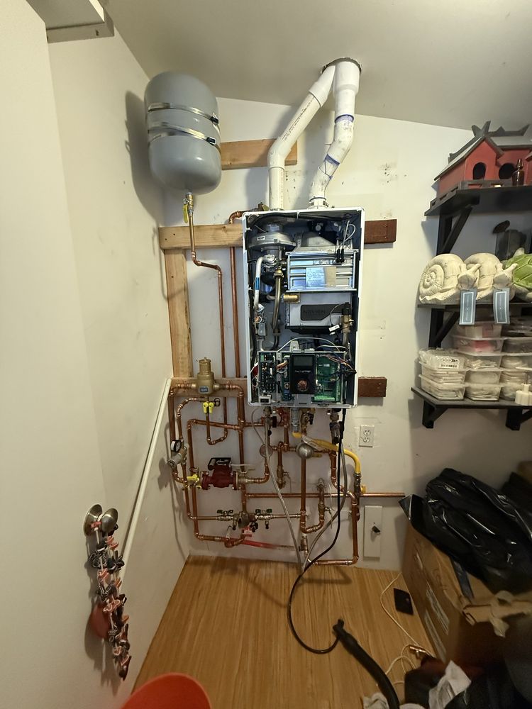 Tankless water heater professionally installed with copper piping and PVC venting