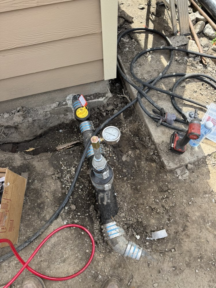 Water pressure regulator and gauge installed on exterior main water line